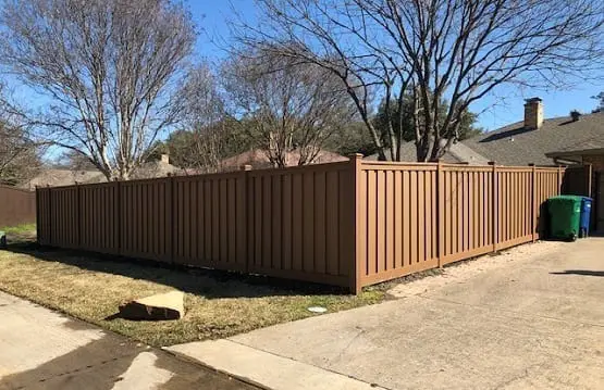 A corner shot of a house with frontyard and driveway composite fence