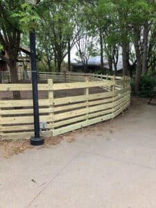 Curved wooden fence at the Dallas Zoo. Fence by Buzz Custom Fence