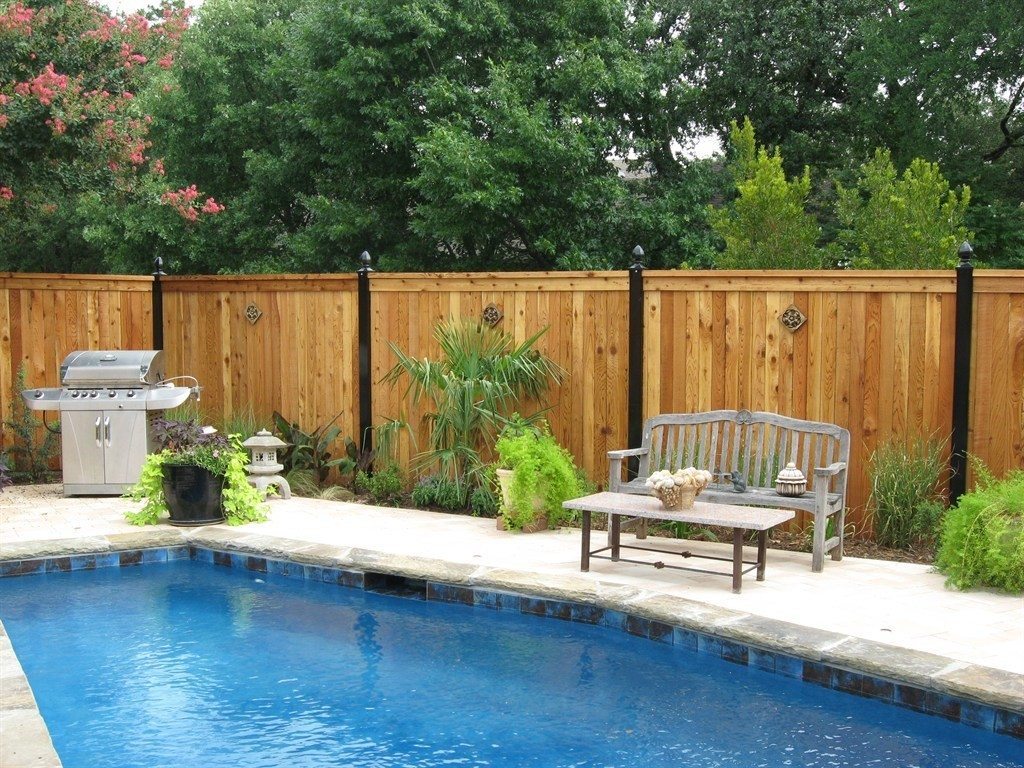 Wood Fence installed by Buzz Custom Fence in a homeowner's backyard